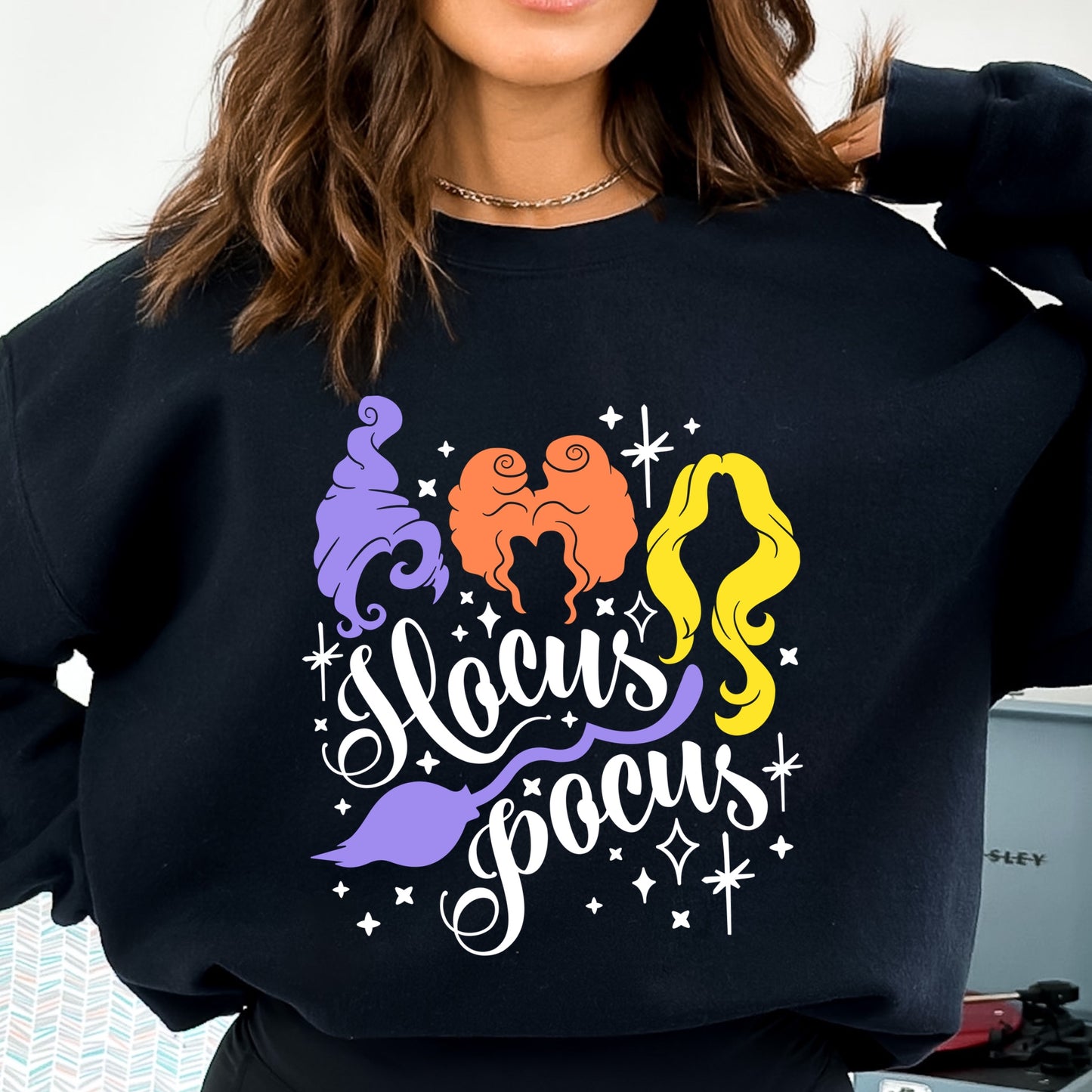 Iron on heat transfer with three witches and the phrase "Hocus Pocus" in white font.
