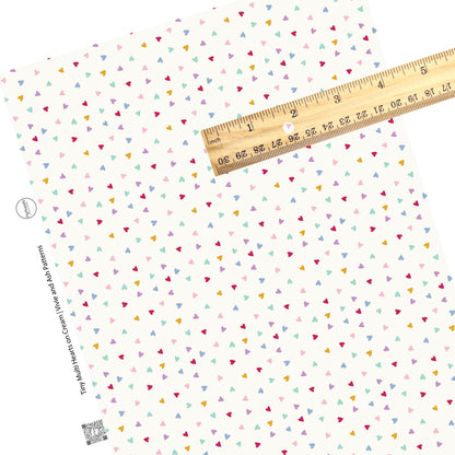 These Valentine's pattern themed faux leather sheets contain the following design elements: tiny multi colored hearts on cream. Our CPSIA compliant faux leather sheets or rolls can be used for all types of crafting projects.