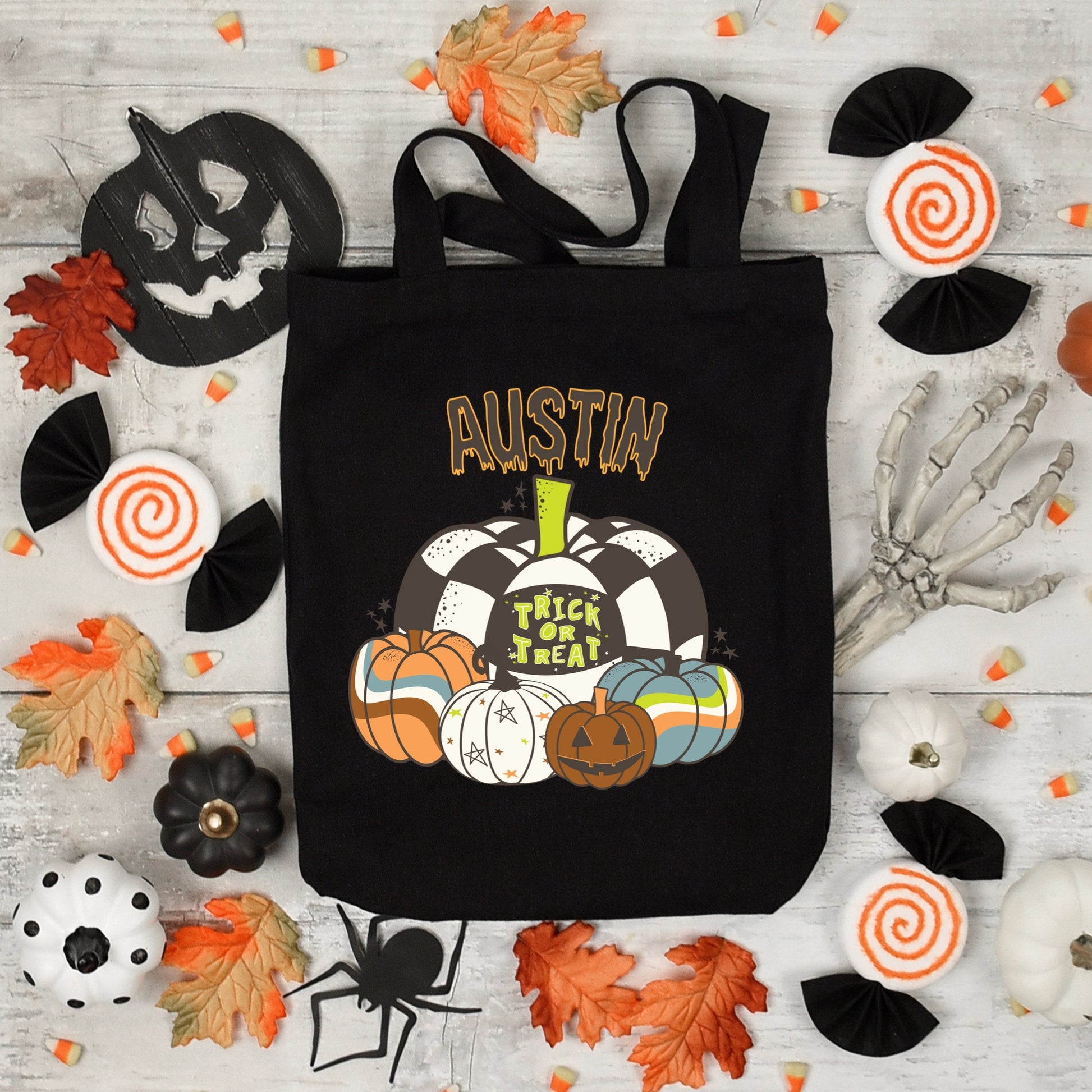 Black Personalized Halloween Trick or Treat Tote Bag with Green, Blue and Orange Pumpkins.