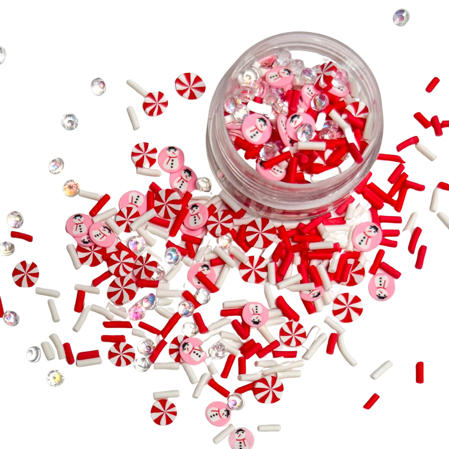 This pink, red and white clay slices mix is versatile for many craft projects. This Christmas mix has pink circles with snowmen, rhinestones, red and white sprinkles, and peppermints. You can use it to add sparkle and decoration to resin projects, filling for shaker bows, slime making, party decor, scrapbooking, card making and nail art.