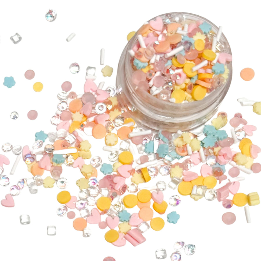 These pastel slices are versatile for many festive craft projects. These lovely pastel floral clays are shaped as pastel dots with clear stones, blue flowers and pink heart designed clay slices. You can use it to add sparkle and decoration to resin projects, filling for shaker bows, slime making, party decor, scrapbooking, card making and nail art.