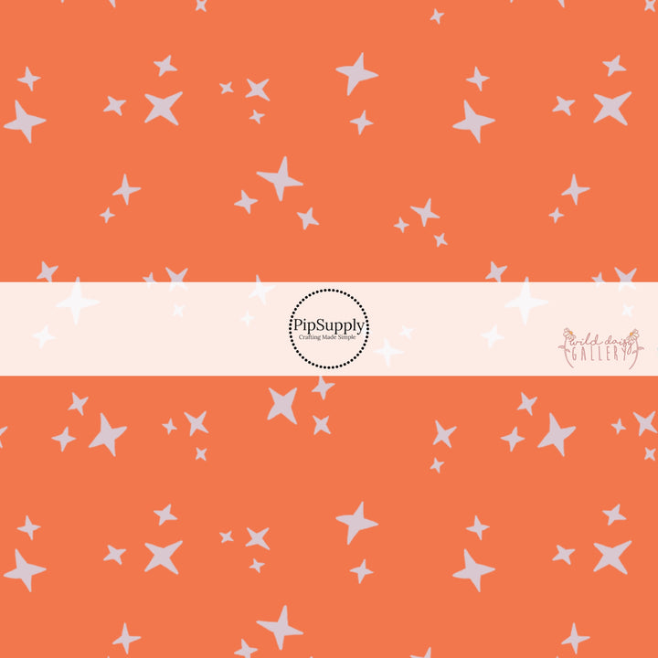 Cream stars on orange fabric by the yard.