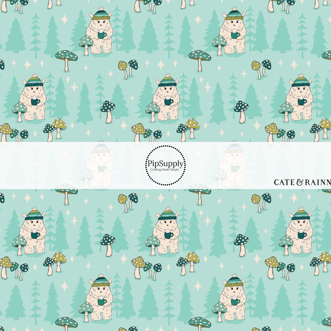 These winter themed pattern fabric by the yard features the following design elements: Yeti wearing a hat and holding hot cocoa on aqua. This fun themed fabric can be used for all your sewing and crafting needs!