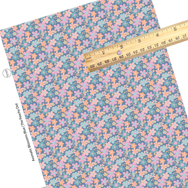 These spring floral pattern themed faux leather sheets contain the following design elements: pink, orange, and light blue flowers on dark blue. Our CPSIA compliant faux leather sheets or rolls can be used for all types of crafting projects.