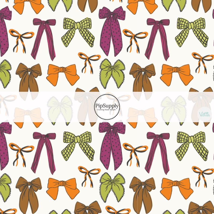 These fall themed pattern fabric by the yard features the following design elements: colorful pattern bows on white. This fun themed fabric can be used for all your sewing and crafting needs!