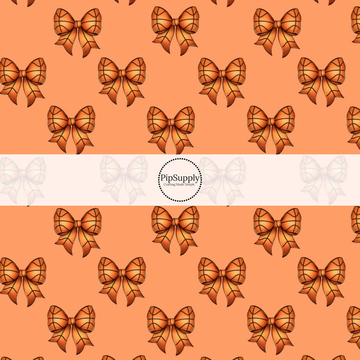 These sports themed fabric by the yard features orange basketball bows. This fun pattern fabric can be used for all your sewing and crafting needs!