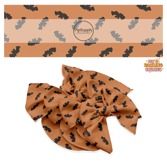 Black bats with mouse ears on orange hair bow strips