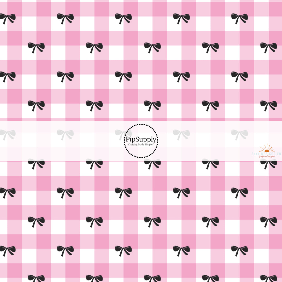 This holiday fabric by the yard features pink plaid and black bows. This festive pattern fabric can be used for all your sewing and crafting needs!