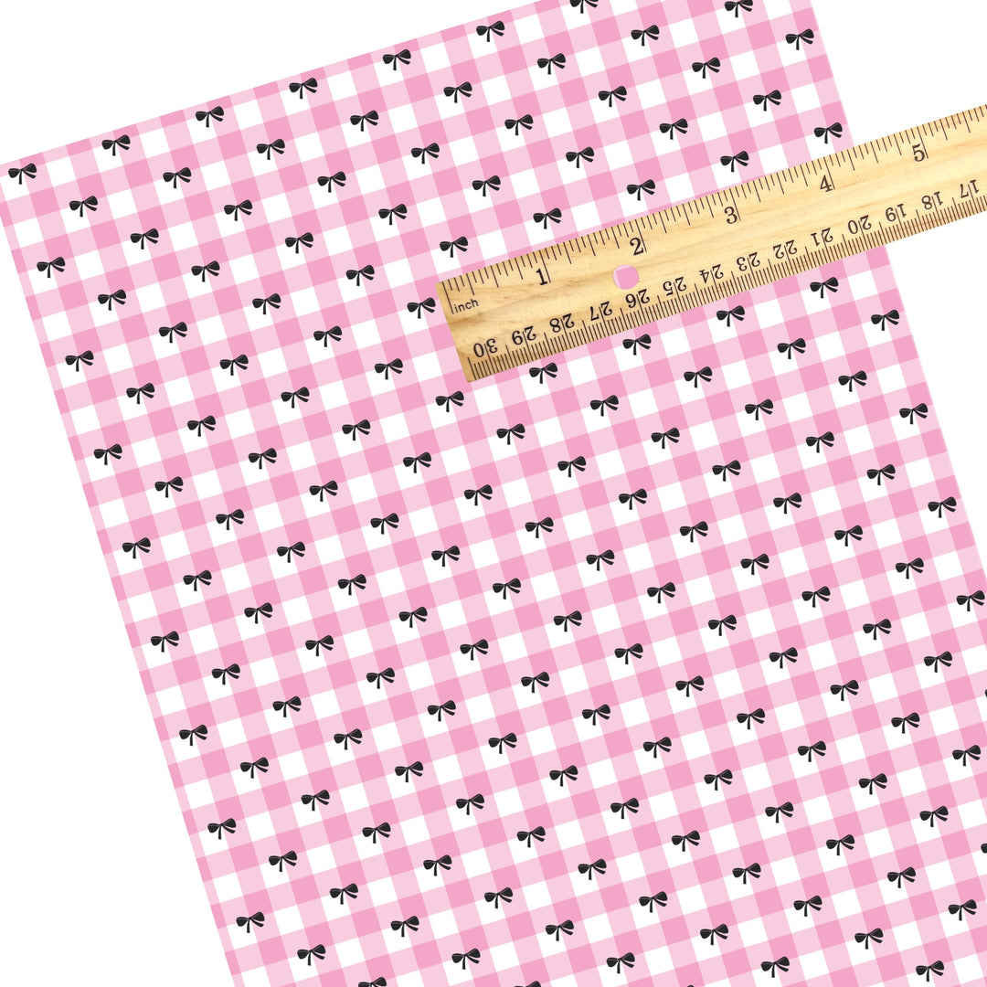 These holiday faux leather sheets contain the following design elements: pink plaid with black bows. Our CPSIA compliant faux leather sheets or rolls can be used for all types of crafting projects.