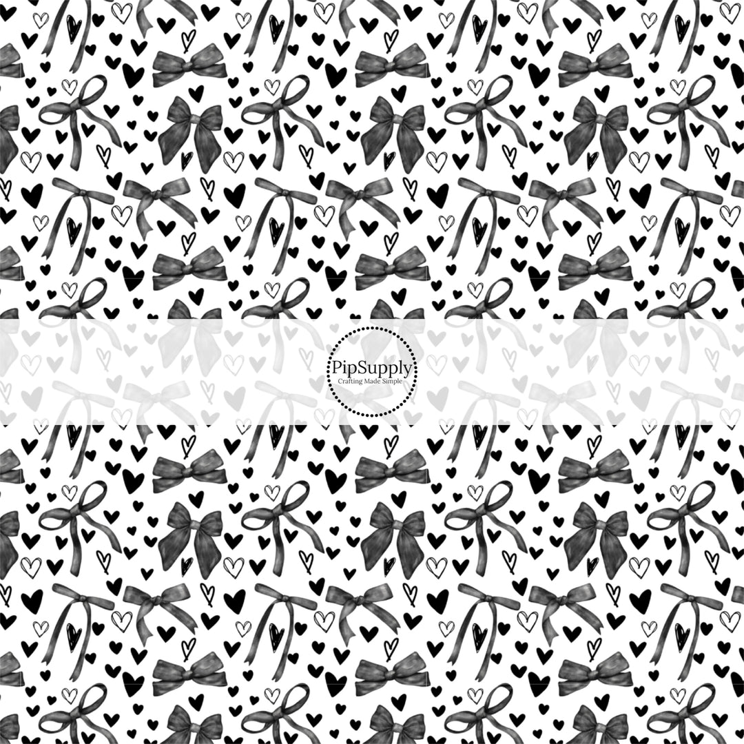 This holiday fabric by the yard features black hearts and bows. This festive pattern fabric can be used for all your sewing and crafting needs!