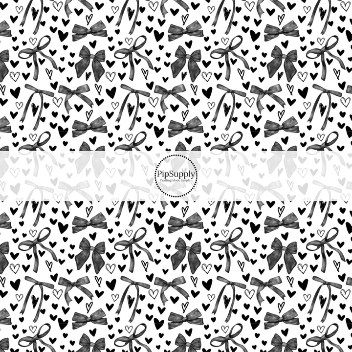 This holiday fabric by the yard features black hearts and bows. This festive pattern fabric can be used for all your sewing and crafting needs!