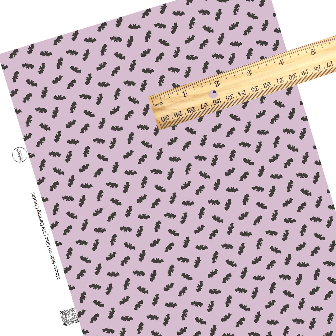 Flying mouse bats on lilac faux leather sheets