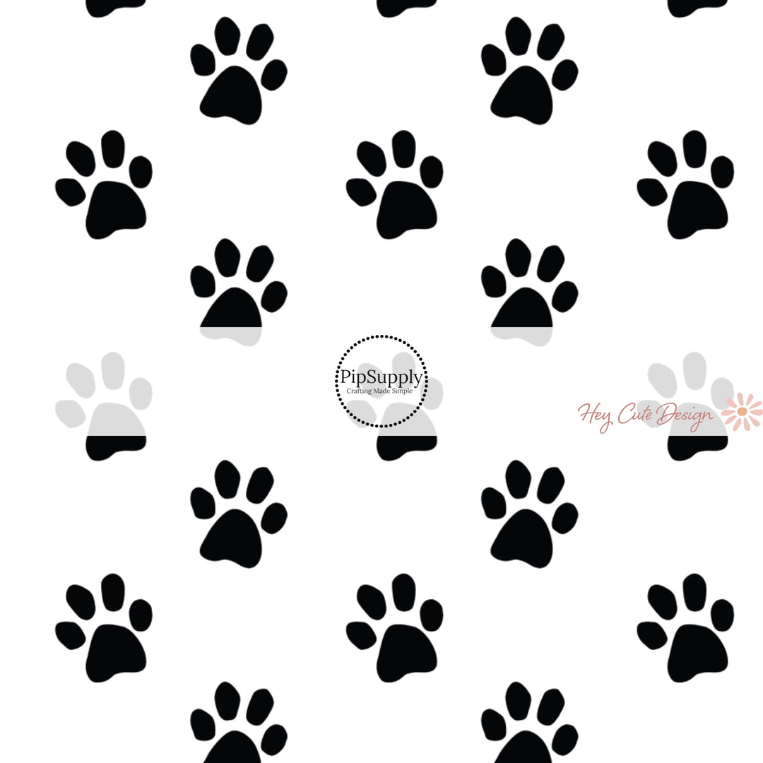 These Halloween themed pattern fabric by the yard features the following design elements: black cat paw prints. This fun spooky themed fabric can be used for all your sewing and crafting needs!