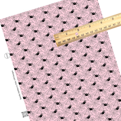 Scattered spiders and webs on pink faux leather sheets