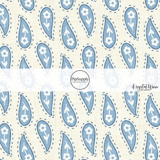 This summer fabric by the yard features western blue paisley pattern on cream. This fun summer themed fabric can be used for all your sewing and crafting needs!