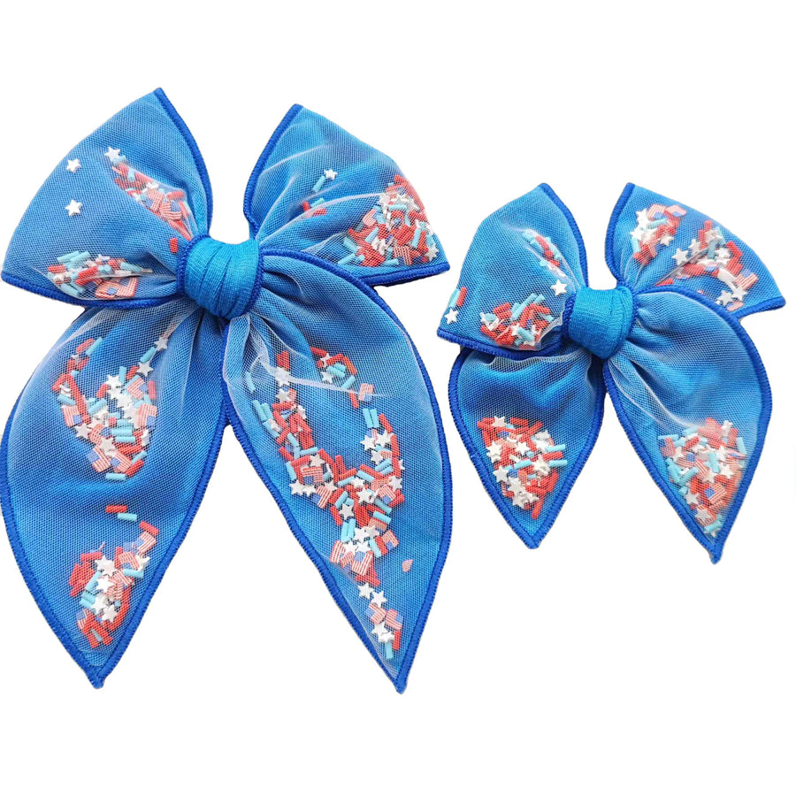 These patriotic blue shaker pre-cut tied bows are ready to package and resell to your customers no sewing or measuring necessary! These hair bows come with a clip already attached. The shaker bows come pre-filled with patriotic stars, American flag, and sprinkle clay mix.