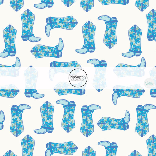 This summer fabric by the yard feature blue rosette cowgirl boots. This fun summer western themed fabric can be used for all your sewing and crafting needs!