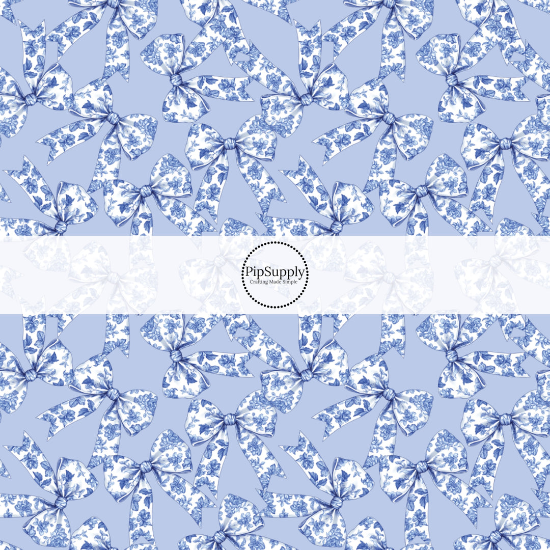 This spring floral themed fabric by the yard features blue bows with floral pattern. This fun pattern fabric can be used for all your sewing and crafting needs!