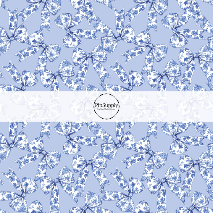 This spring floral themed fabric by the yard features blue bows with floral pattern. This fun pattern fabric can be used for all your sewing and crafting needs!