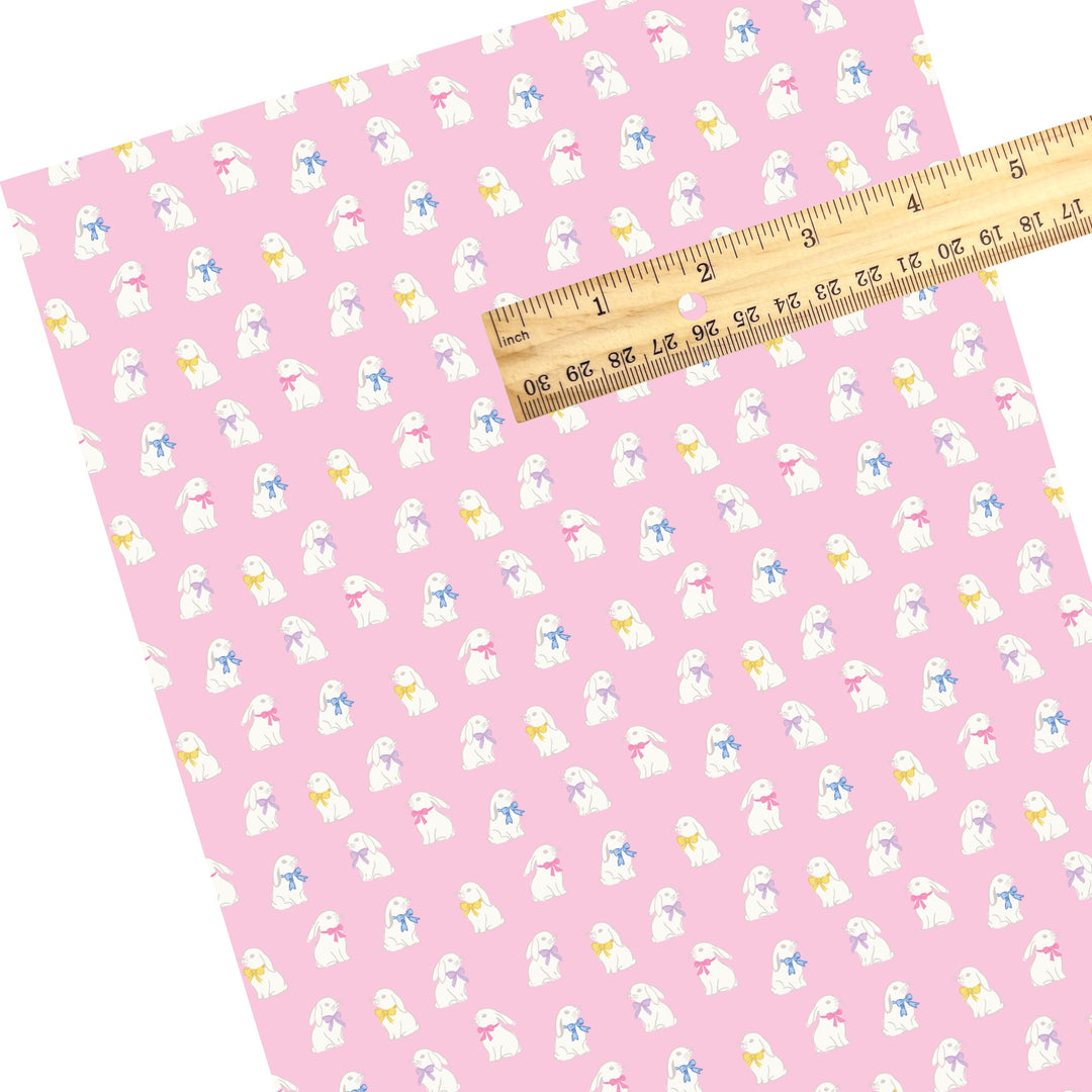 These Easter themed faux leather sheets contain the following design elements: white bunnies with colorful bows on pink. Our CPSIA compliant faux leather sheets or rolls can be used for all types of crafting projects.