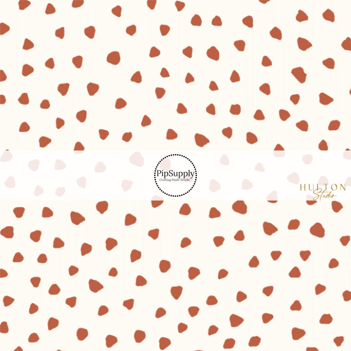 These speckled themed fabric by the yard features small brown speckled dots on ivory. This fun dotted themed fabric can be used for all your sewing and crafting needs! 