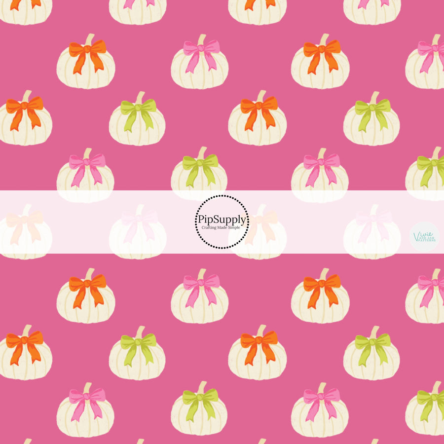 These Halloween themed pattern fabric by the yard features the following design elements: white pumpkins with bows on pink. This fun themed fabric can be used for all your sewing and crafting needs!