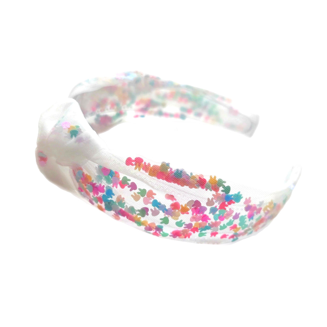 These Easter themed tulle knotted headbands are a stylish hair accessory having the look of a knotted headwrap and the on and off ease of a headband. Made with high quality fabric these headbands are a perfect simple and fashionable answer to keeping your hair back! Between the tulle and headband is a clay mix of colorful bunnies.