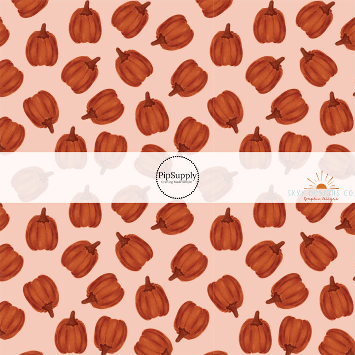 These autumn themed pattern fabric by the yard features the following design elements: burnt orange pumpkins. This fun themed fabric can be used for all your sewing and crafting needs!