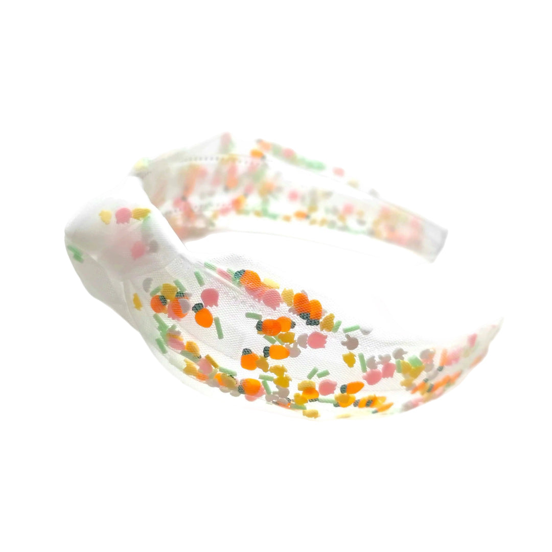 These Easter themed tulle knotted headbands are a stylish hair accessory having the look of a knotted headwrap and the on and off ease of a headband. Made with high quality fabric these headbands are a perfect simple and fashionable answer to keeping your hair back! Between the tulle and headband is a clay mix of carrots and bunnies.