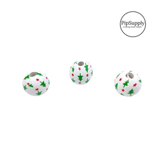 Green trees and pink stars on white wooden bead embellishment