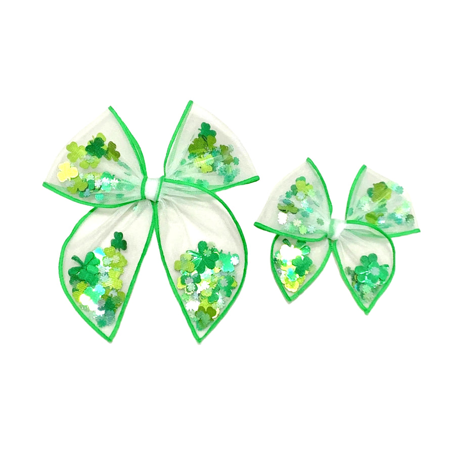 These St. Patrick's Day green stitched white tulle pre-cut shaker tied bows are ready to package and resell to your customers no sewing or measuring necessary! These hair bows come with a alligator clip already attached and come filled with a green clover mix.