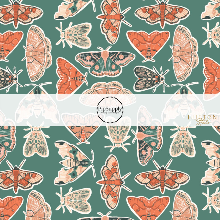 These fall themed dark green fabric by the yard features multi-colored cream, orange, and green moths on dark green. This fun animal themed fabric can be used for all your sewing and crafting needs! 