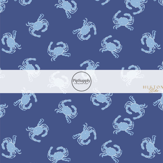 This summer fabric by the yard features light blue crabs on dark blue. This fun themed fabric can be used for all your sewing and crafting needs!