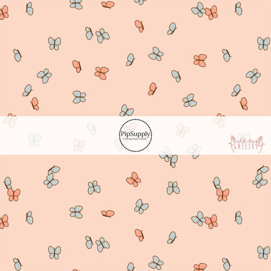 These butterfly themed light cream fabric by the yard features small butterflies in light orange and light blue. 