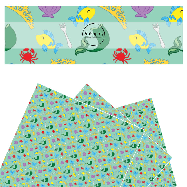 Mermaid tail, crabs, fish, seashells, and fork on green faux leather sheets