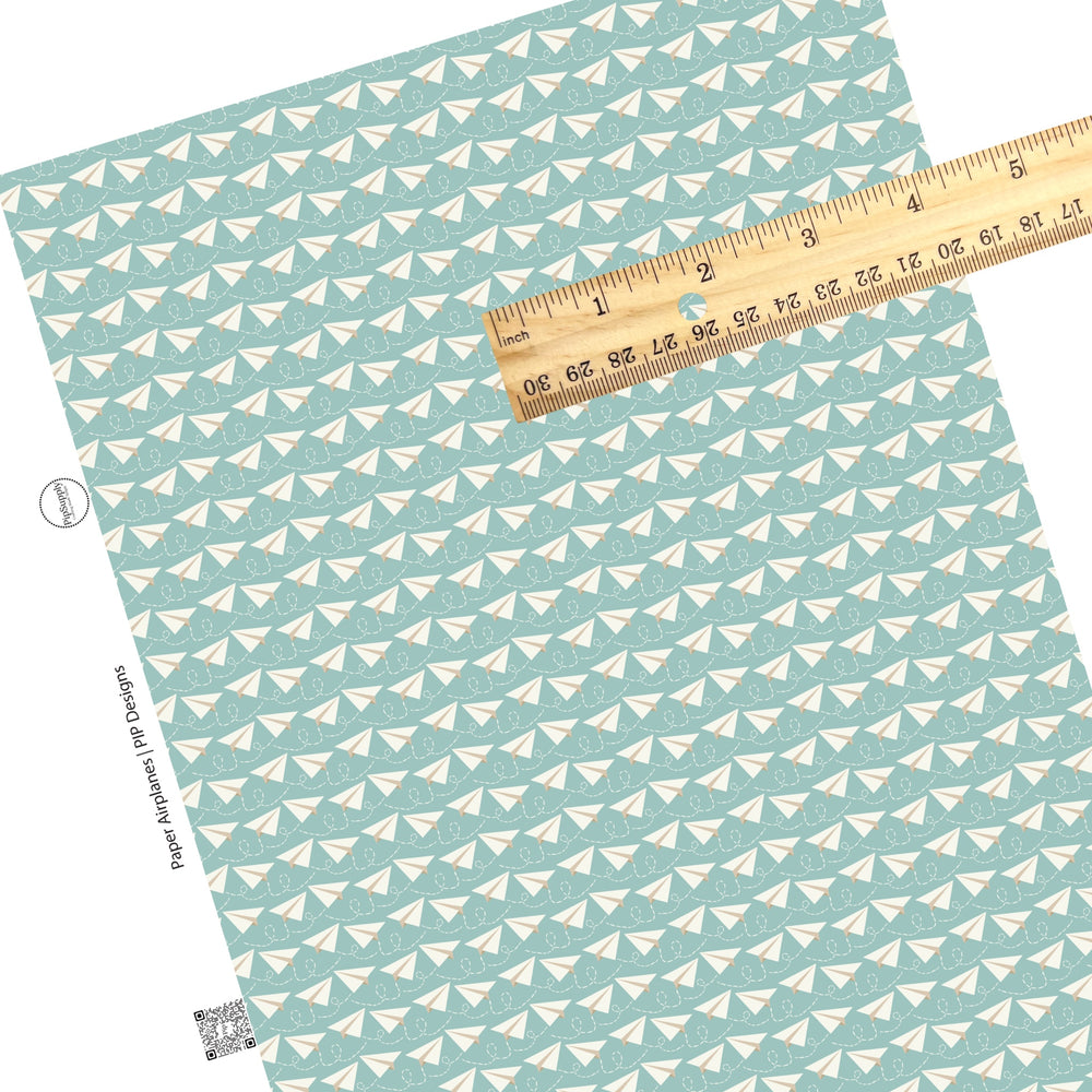 Dotted trail with paper airplane on blue faux leather sheets