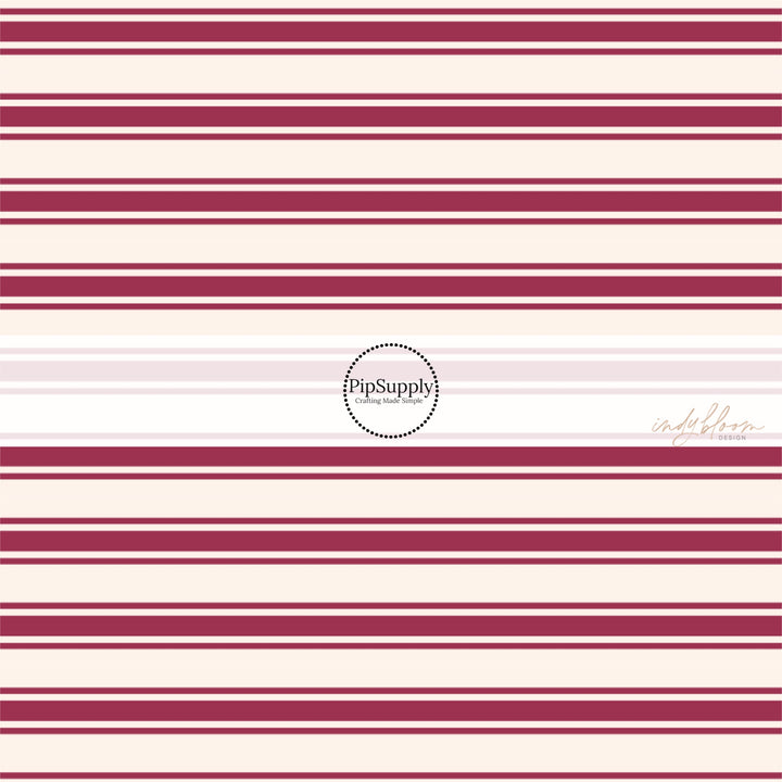 These stripe themed fabric by the yard features mulberry thin and thick stripes on cream. This fun stripe themed fabric can be used for all your sewing and crafting needs! 