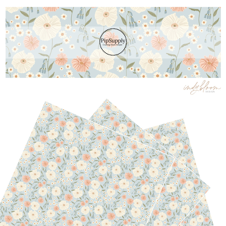 These pastel flowers in a meadow on light blue faux leather sheets contain the following design elements: tan, orange, cream, pink, and blush flowers.