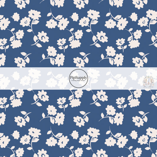 These floral themed dark blue fabric by the yard features light cream flowers on navy blue. This fun summer floral themed fabric can be used for all your sewing and crafting needs! 