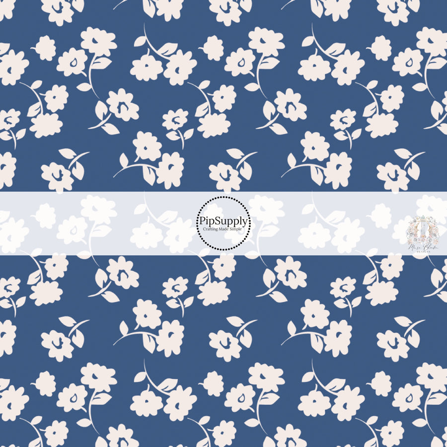 These floral themed dark blue fabric by the yard features light cream flowers on navy blue. This fun summer floral themed fabric can be used for all your sewing and crafting needs! 