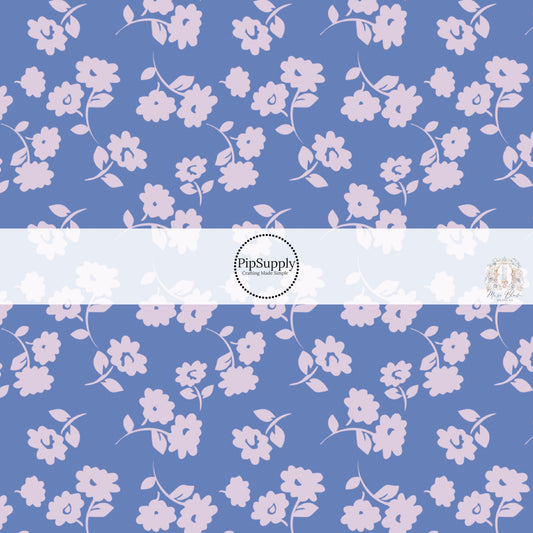 These floral themed dark purple fabric by the yard features light periwinkle flowers on lilac. This fun summer floral themed fabric can be used for all your sewing and crafting needs! 