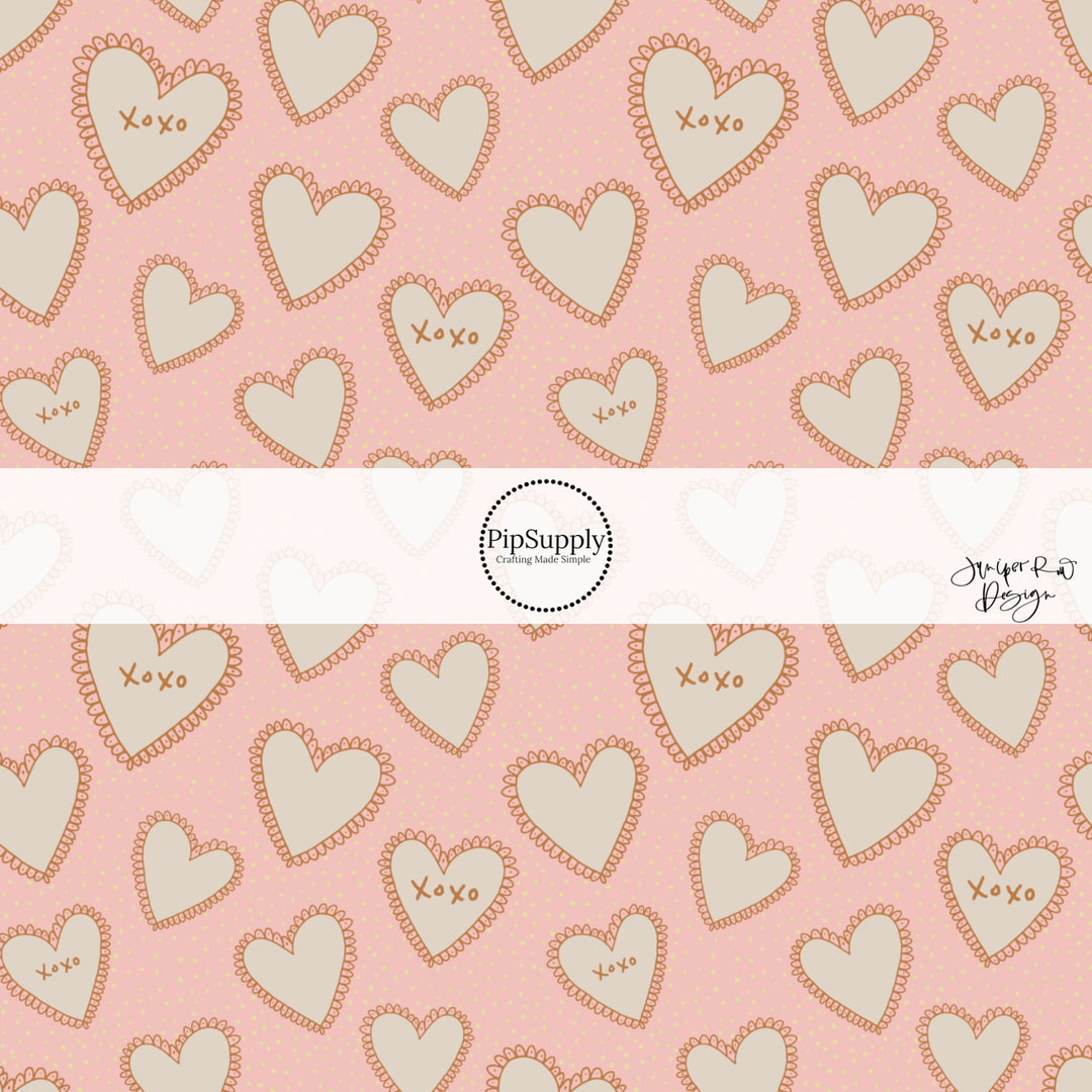 This holiday fabric by the yard features cream lace hearts on pink. This festive pattern fabric can be used for all your sewing and crafting needs!