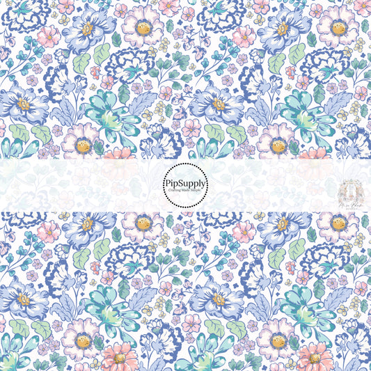 These floral themed cream fabric by the yard features navy blue, light blue, teal, light pink, cream, yellow, and aqua flowers on cream. This fun summer floral themed fabric can be used for all your sewing and crafting needs! 