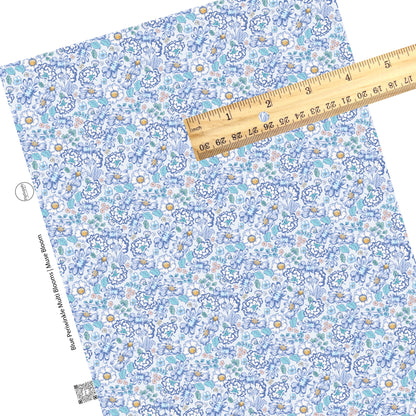 These floral themed blue faux leather sheets contain the following design elements: navy blue, light blue, cream, yellow, and aqua flowers on periwinkle. 