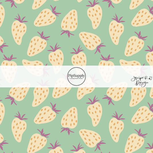 These fruit themed light mint fabric by the yard features cream strawberries with orange seeds with purple stems on light mint.