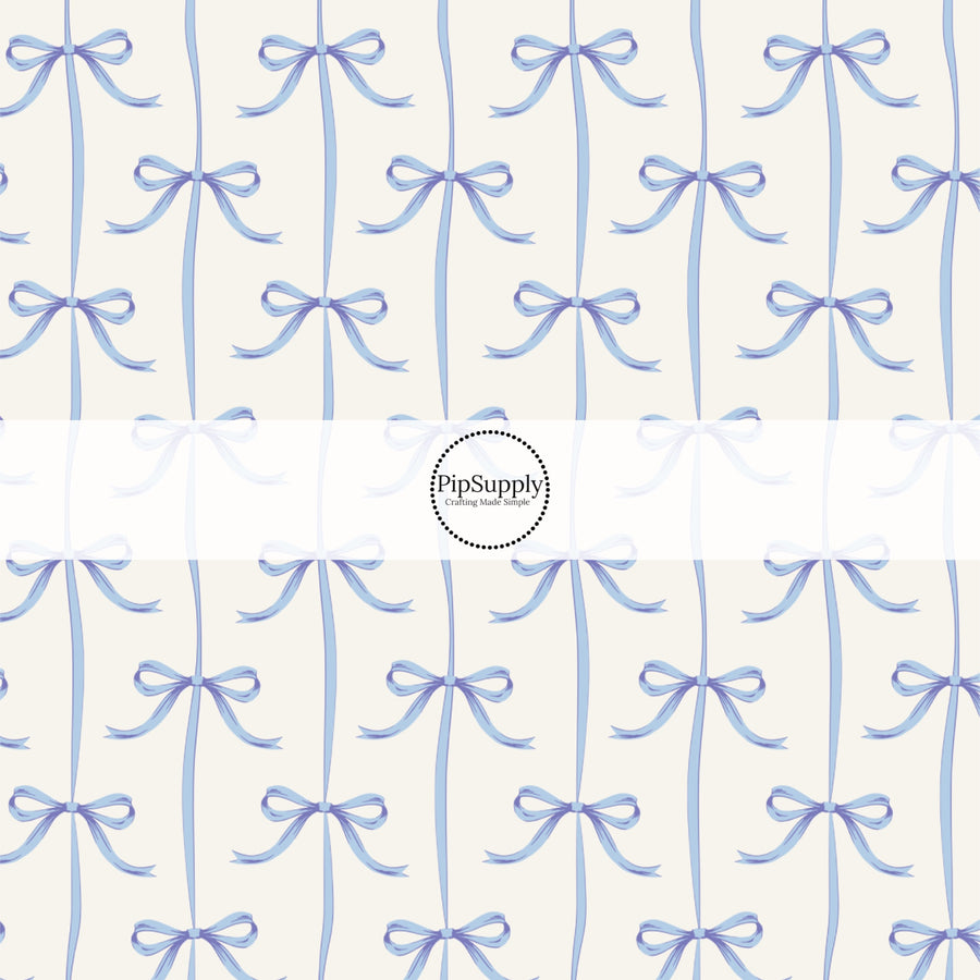 This spring fabric by the yard features blue bows on white. This fun pattern fabric can be used for all your sewing and crafting needs!