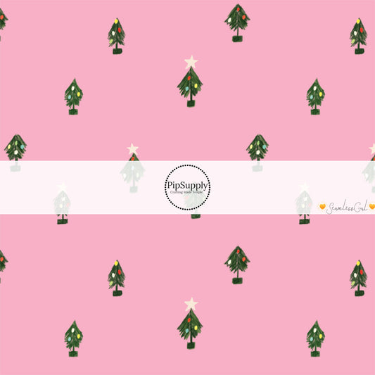 These Christmas themed pattern fabric by the yard features the following design elements: tiny Christmas trees on pink. This fun themed fabric can be used for all your sewing and crafting needs!