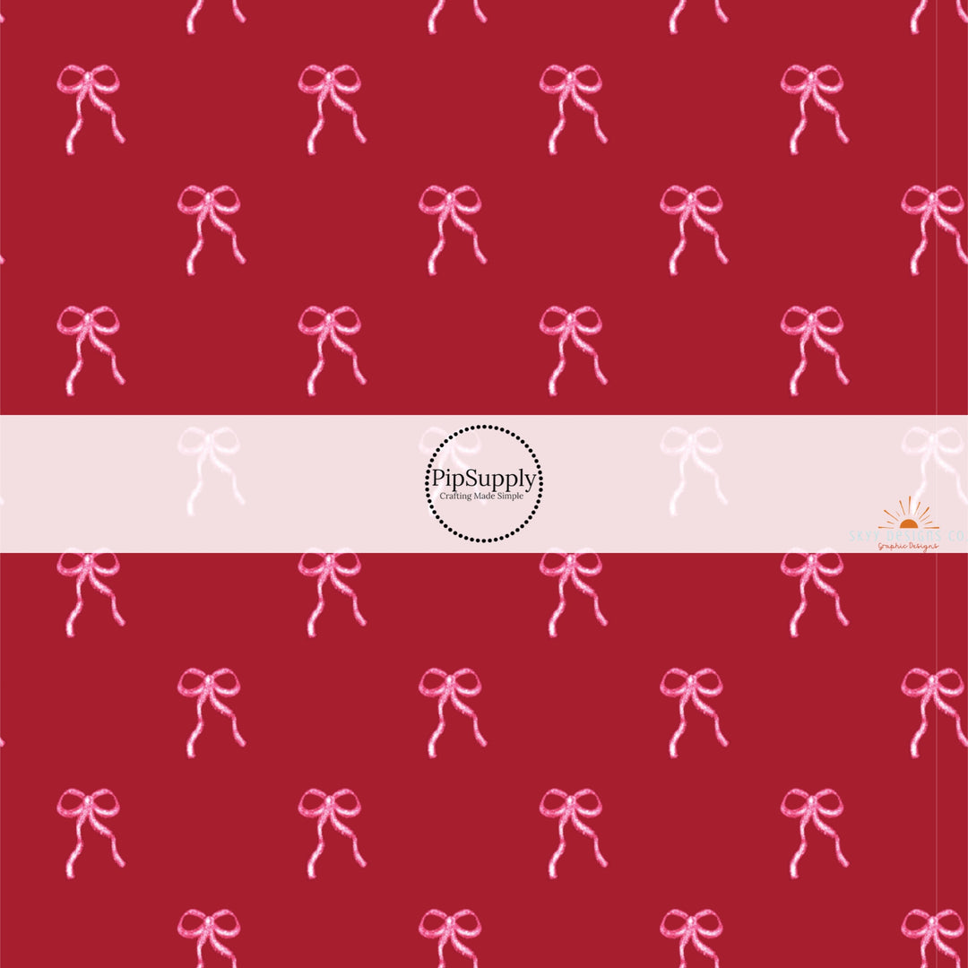 This holiday fabric by the yard features pink bows on cranberry red. This festive pattern fabric can be used for all your sewing and crafting needs.