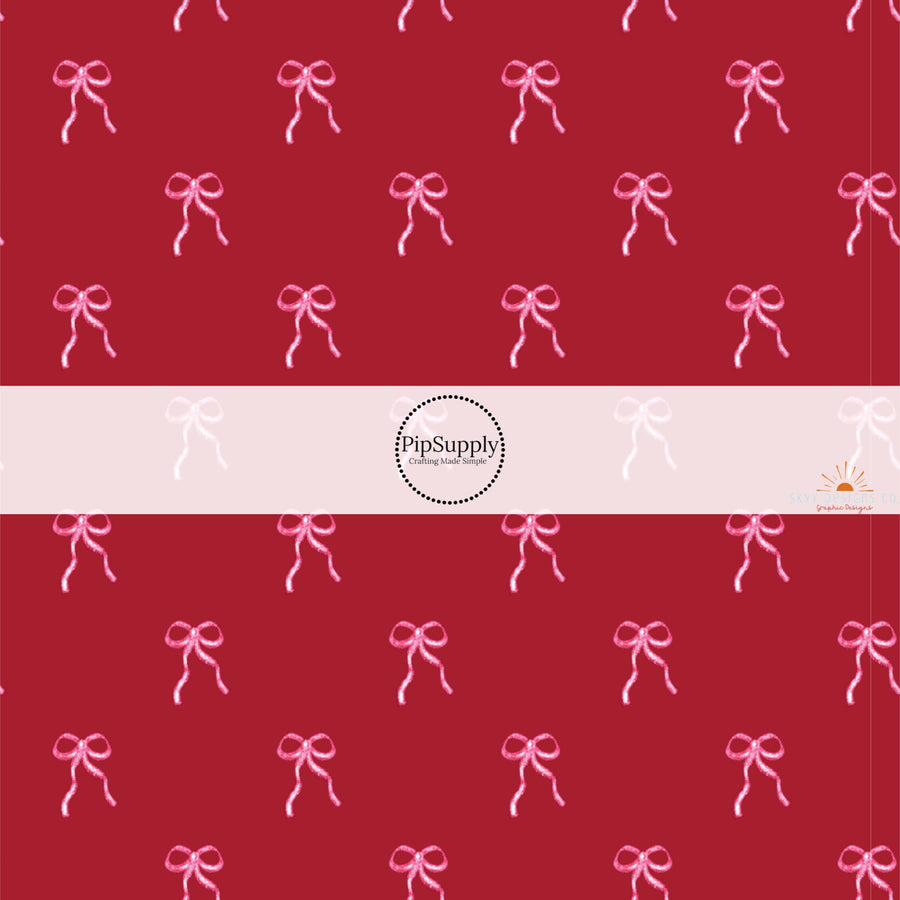 This holiday fabric by the yard features pink bows on cranberry red. This festive pattern fabric can be used for all your sewing and crafting needs.