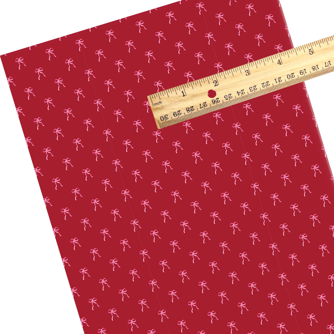 These holiday faux leather sheets contain the following design elements: pink bows on cranberry red. Our CPSIA compliant faux leather sheets or rolls can be used for all types of crafting projects.